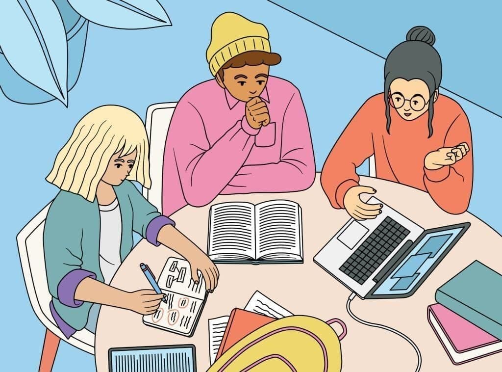 People crowded around a desk looking at books and computers studying