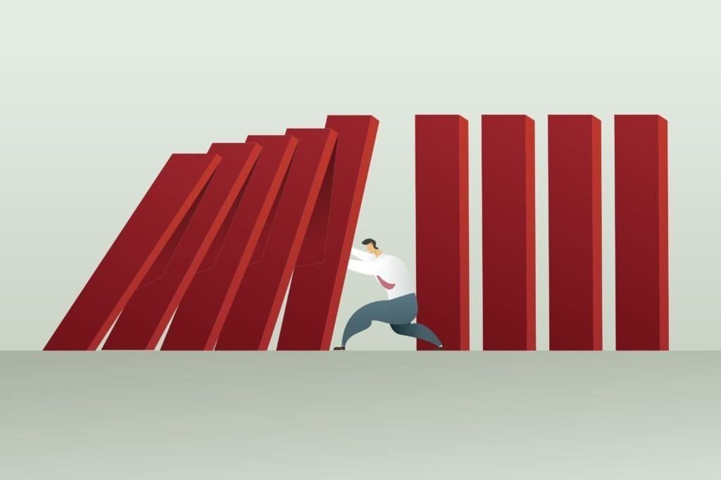 How to Choose a UK Trading Platform 9 man pushing heavy objects which look like they might fall - indicating risk